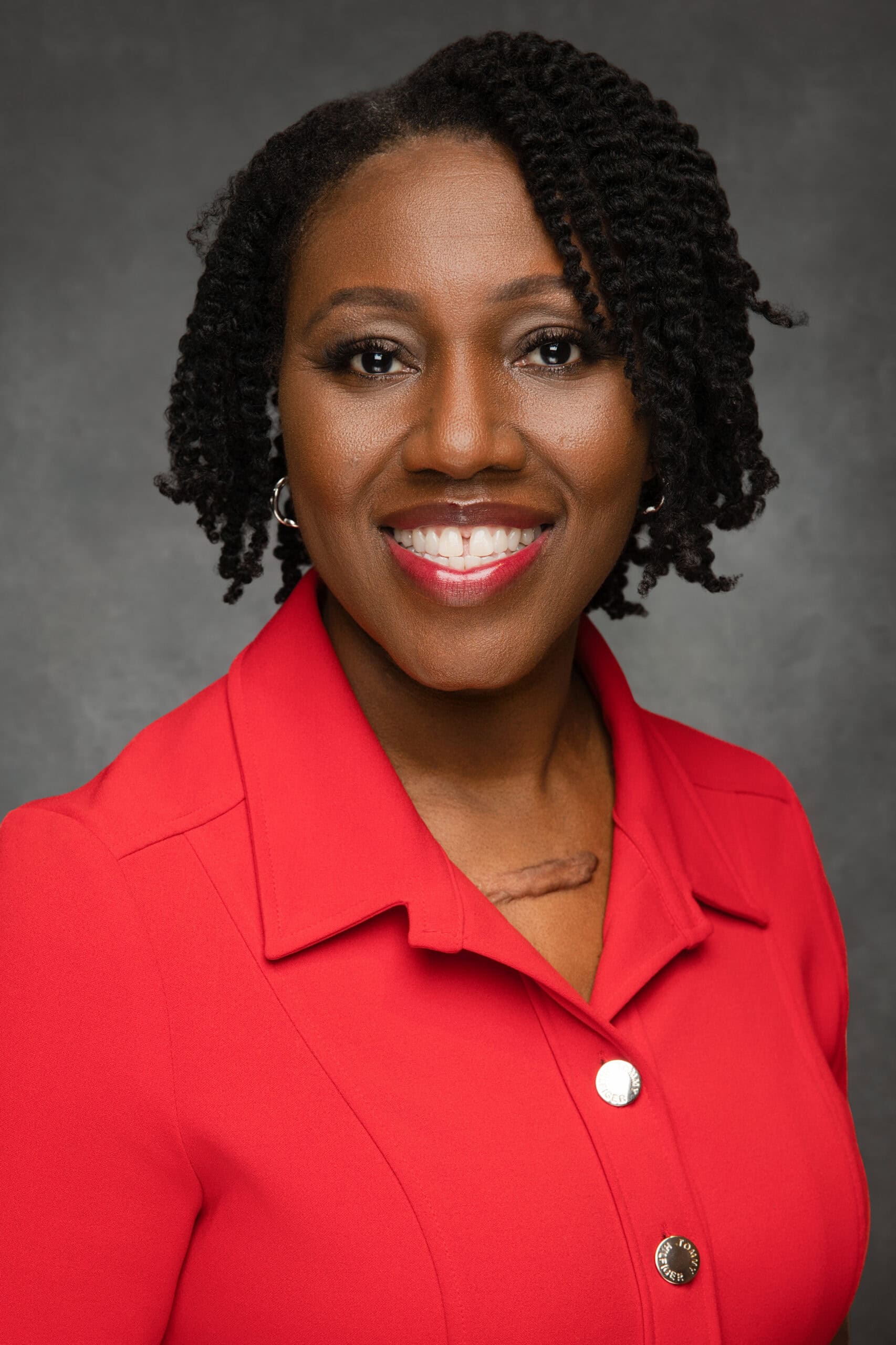 Brandy in a red dress facing the camera